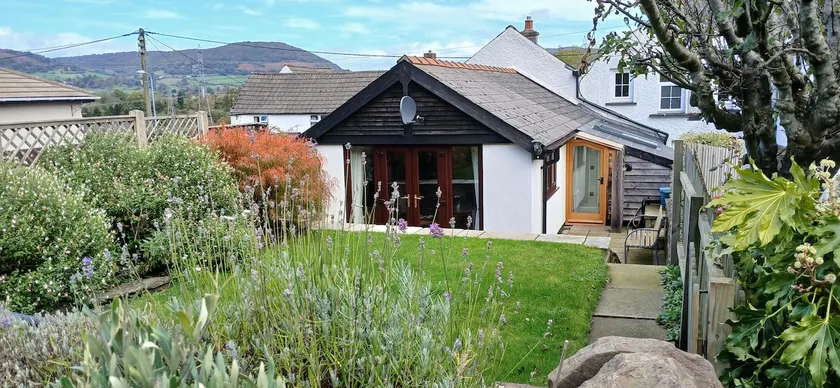 A charming cottage with mountain & woodland views - Image 1