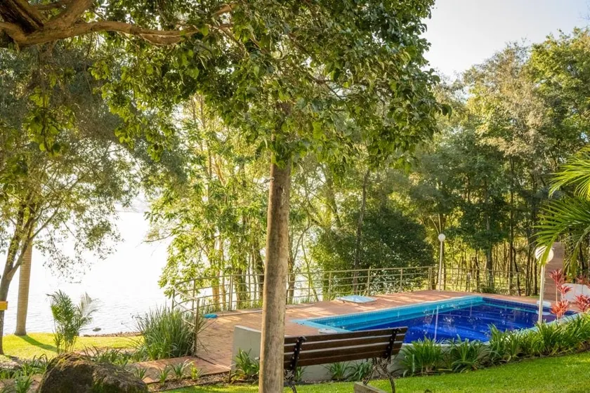 Lake house with swimming pool integrated into nature - Image 1