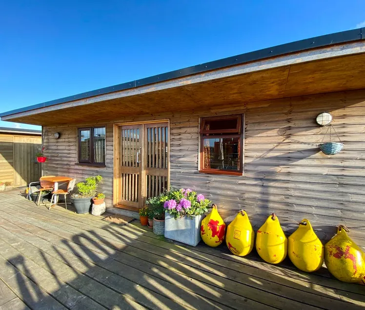 Riverbank Retreat, a cosy cabin on the waterfront. - Image 1
