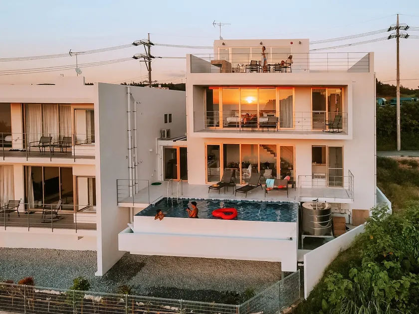 Blue Rela Luxe Resort Okinawa, a villa with a pool surrounded by nature - Image 1