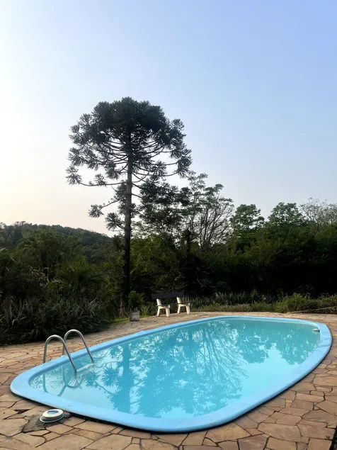 A property with a swimming pool, barbecue area and green area - Image 1