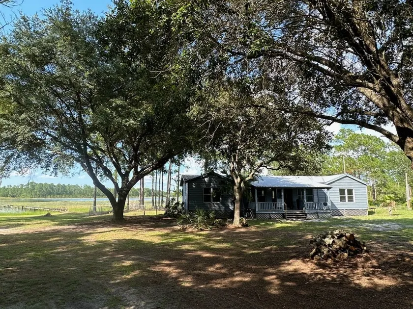 Secluded forest home on lakefront - Image 1
