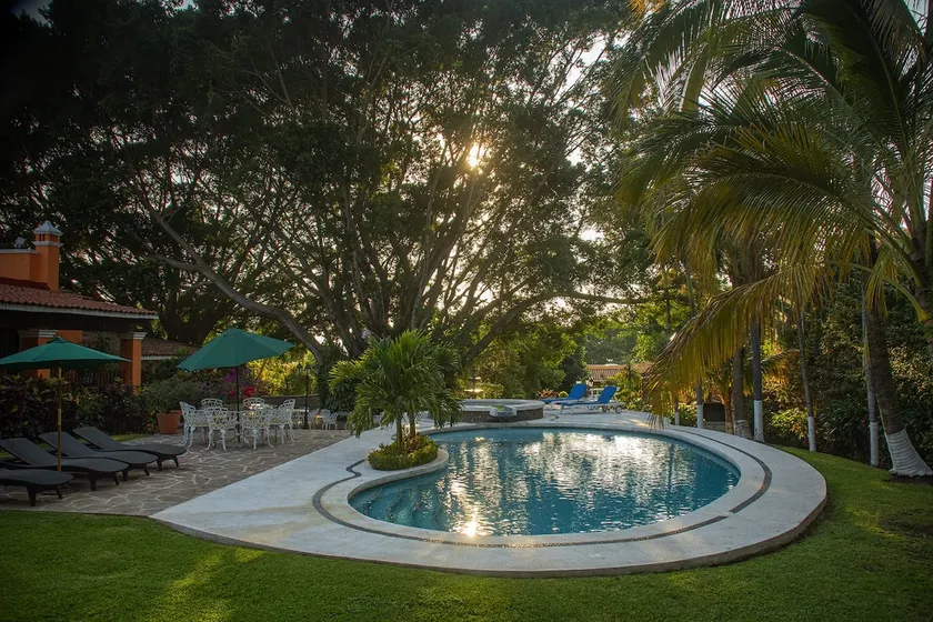 A villa with a swimming pool, jacuzzi, tennis court, and squash - Image 1