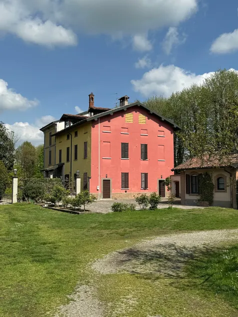 Red house surrounded by greenery - Image 1