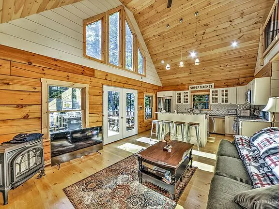 Modern lakefront log cabin with sunset views. - Image 1