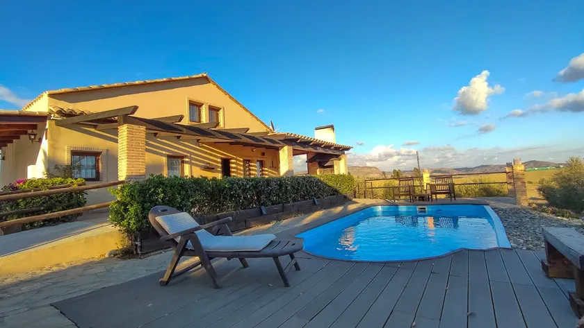 A rural house with a swimming pool and surrounded by nature - Image 1