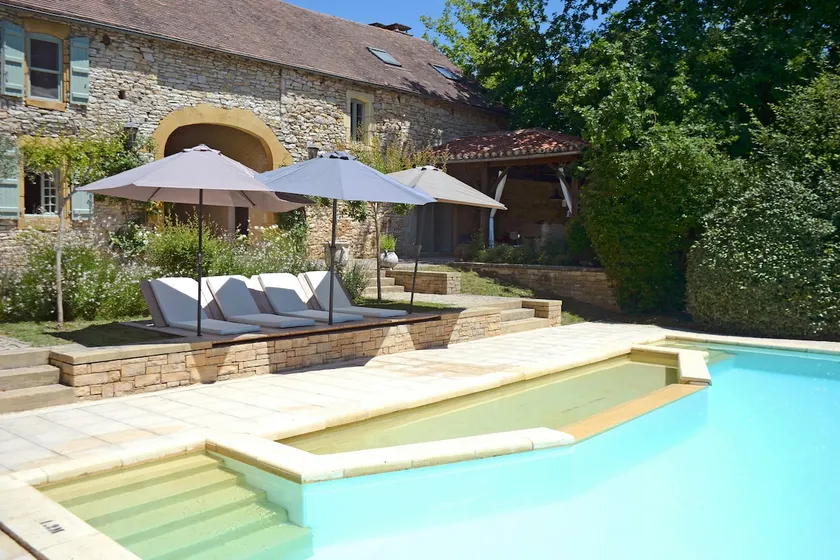Stone barn with a swimming pool and lake. - Image 1