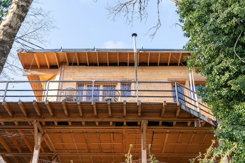 Wooden and straw house on stilts. - Image 1