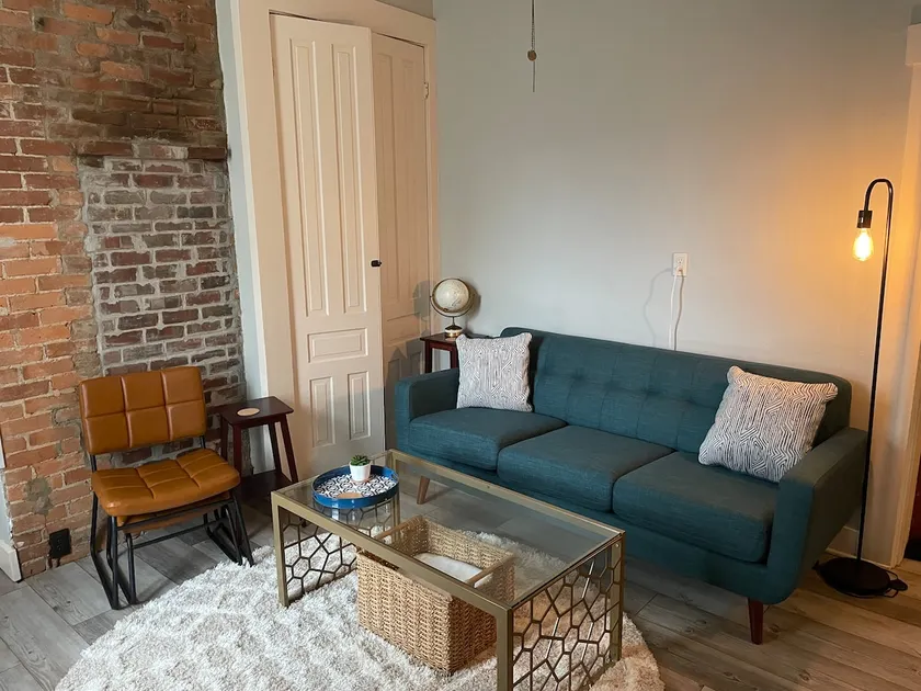 Historic Red Brick Home with Patio & Full Kitchen - Image 1