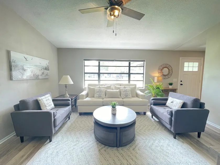 Stunning home with screened patio & fenced yard - Image 1