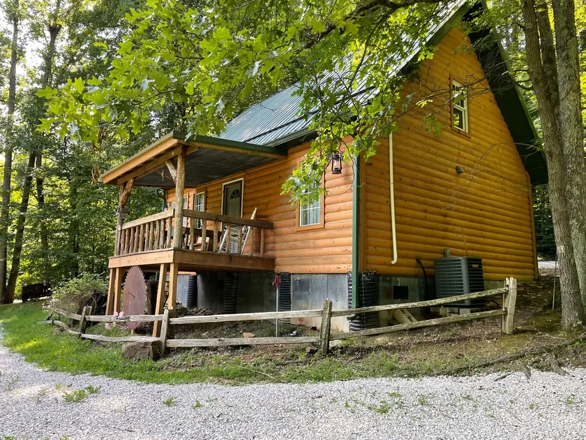 Cozy cabin nestled in the woods. - Image 1