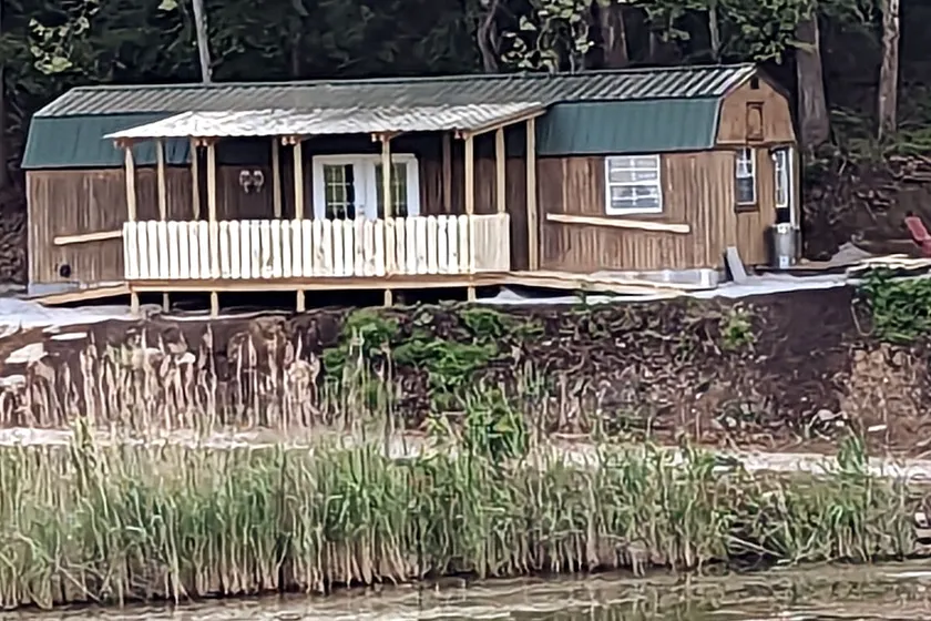 The Sunnyside is a unique 14x40 cabin by the water - Image 1