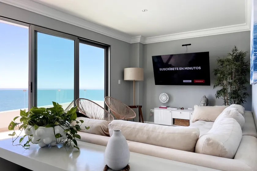 A beachfront property with a view of the marina and a heated pool - Image 1