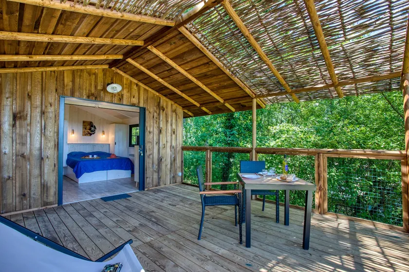 Wooden cabin on stilts at the campsite - Image 1