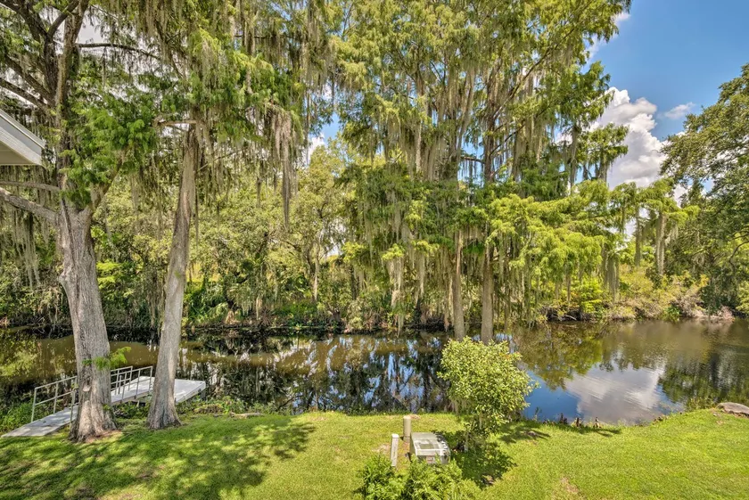 Old Florida Setting w/ Kayaks & Fishing Poles - Image 1