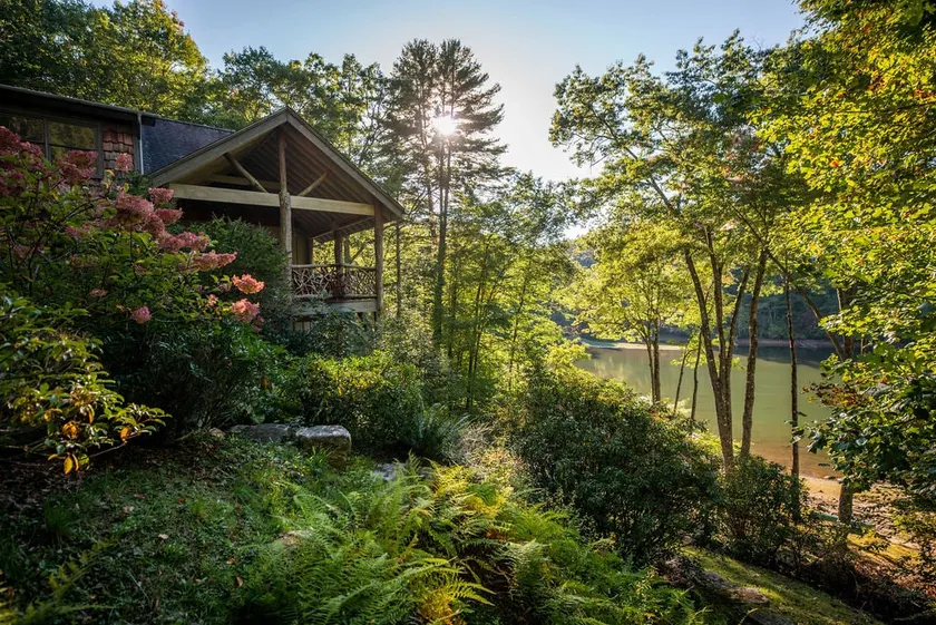 Lake front with private dock, fire pit, hammock, pool table & gorgeous views! Fishing poles, paddle boards & canoe provided. - Image 1