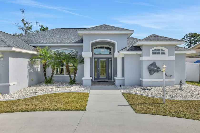 Contemporary coastal escape with heated pool, fenced yard, & outdoor dining - Image 1