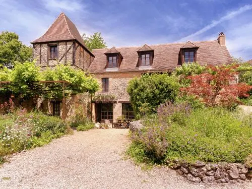 A romantic hamlet with lush gardens on a hill. - Image 1