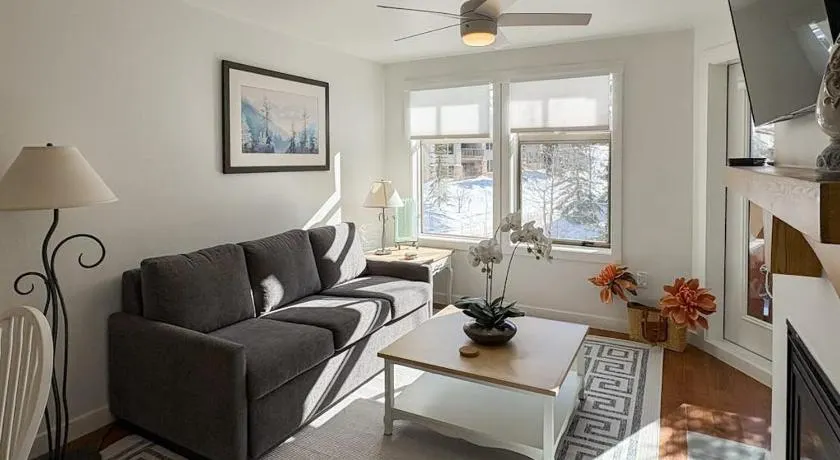 ski-in - ski-out condo with a deck ski views & a shared pool and hot tub - Image 1