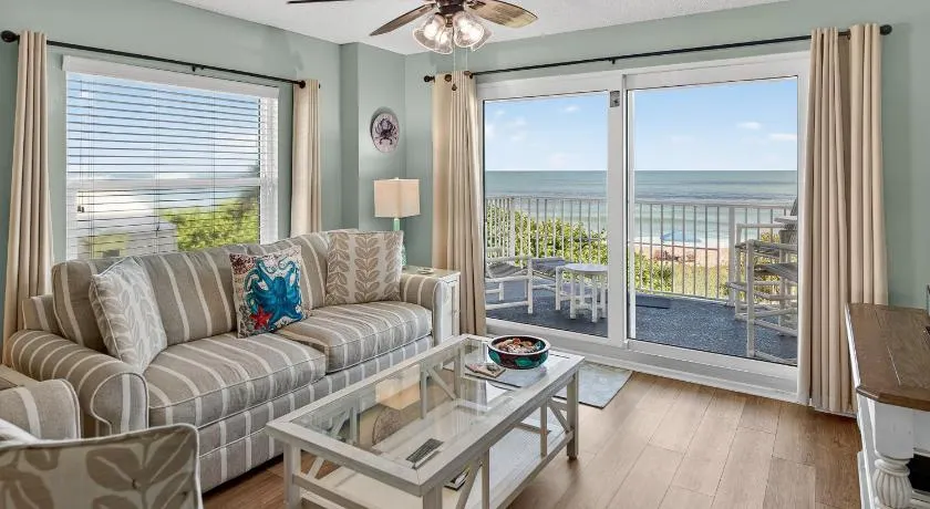 Direct oceanfront 2/2 corner condo with large balcony, heated pool, and garage parking - Image 1