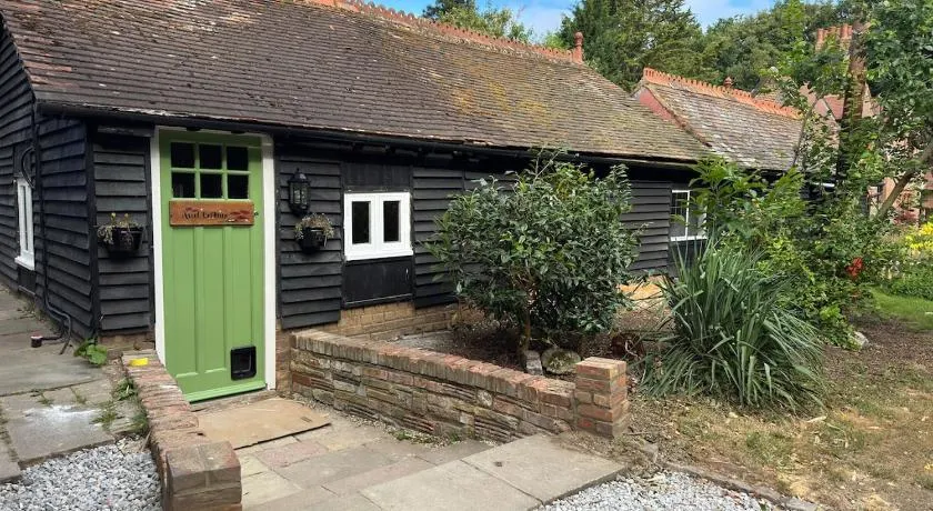 A charming cottage nestled in a peaceful woodland - Image 1