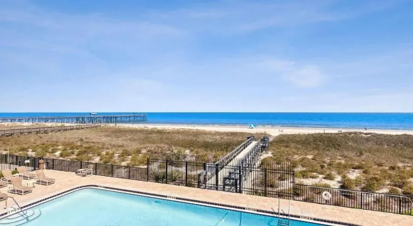 Ocean-view condo with a scenic balcony & W/D - pool and beach access - Image 1