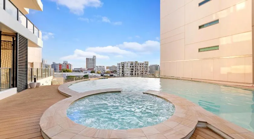 High-Rise Modern Oasis with Pool and City Views - Image 1