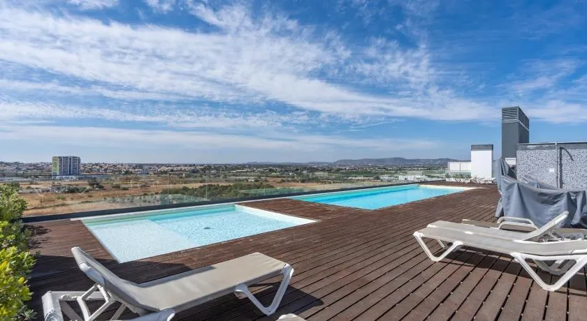 Rooftop Pools & Balcony Haven by HostWise - Image 1