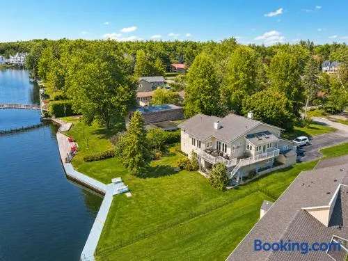 Canalside Summer Cottage with Waterview, Custom Bar, BBQ, and Fireplace - Image 1