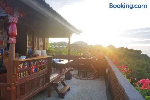 The Hidden Escapes Bingin- Sunset Rooftop Wood House with Ocean View & Private Kitchen - Image 1