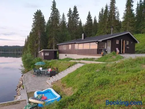 Idyllic lakeside cabin with private beach and boat - Image 1