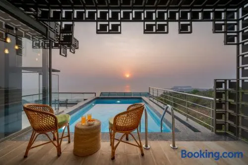 SaffronStays Nautica - 5BR hilltop villa with rooftop pool, sea views & modern interiors surrounded by greenery - Image 1