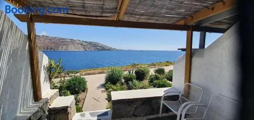 Panoramic View of Ornos Bay in Mykonos & Pool by ΜΡS - Image 1