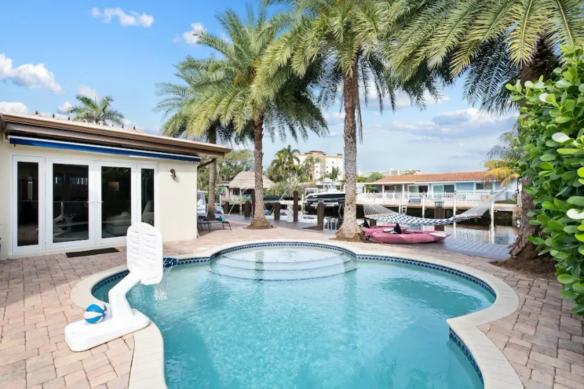 Beachy Tiki Waterfront Home with Boat Dock~Free Kayaks~Heated Pool~Games~Hammock~Sunrise Yoga - Image 1