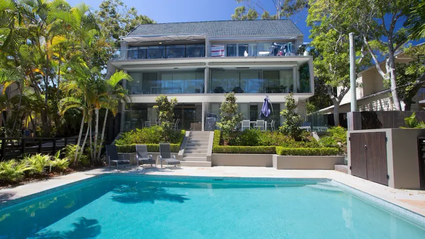 Relax by the pool whilst enjoying the landscaped garden and Laguna Bay views - Image 1