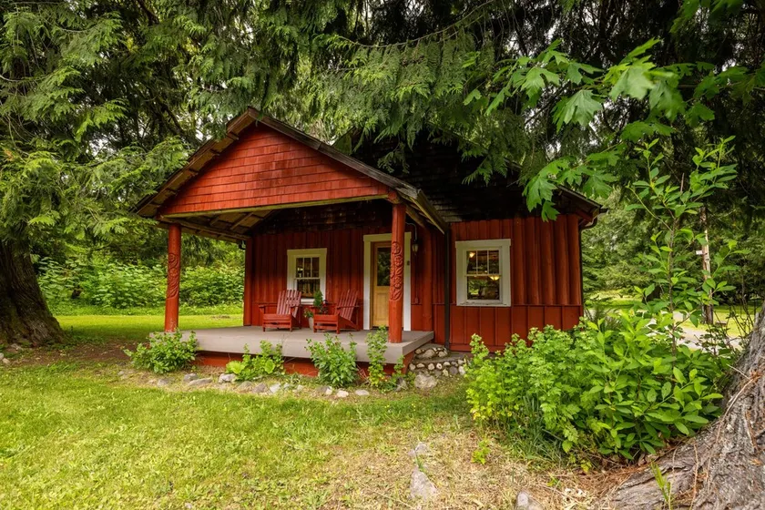 This historic cabin is just a few miles from Mt Rainier National Park. Pet friendly. Fish pond, pastures, old cedars, 11-acres. Private hot tub surrounded by grove of old cedars. - Image 1