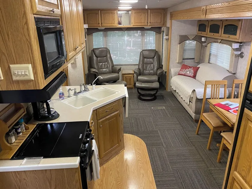 Betsie -35Ft RV Camper in Woods -Firepit & Hot Tub - Image 1