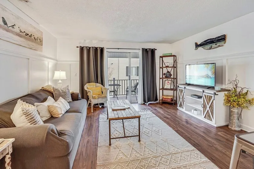 One-bedroom sleeps 4 with sleeper sofa, complex has 2 pools, tennis courts, playground, large pond, walking distance to pier village and less than a mile to public beach access. - Image 1