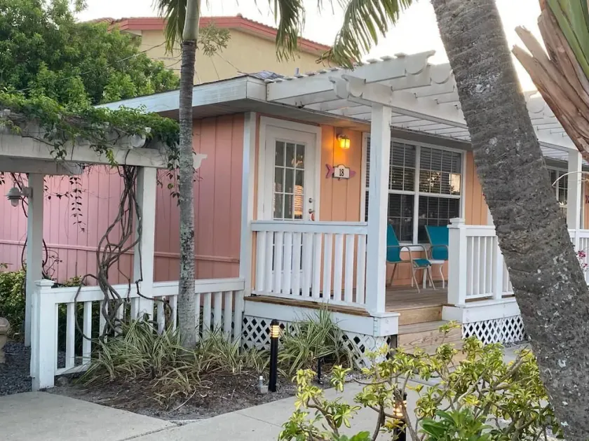 Beach across the road, pool a few steps out the door of this charming cottage. - Image 1