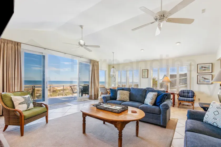 Spacious living area, windows across entire length of home. - Image 1