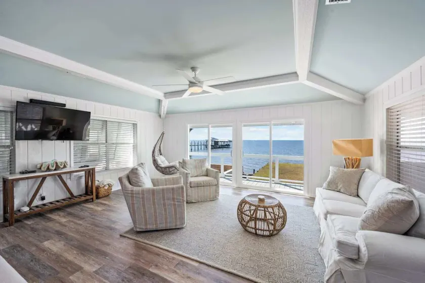 A beautifully designed 4BR/3BA cottage on Mobile Bay, with a large yard, screened porch and private fishing pier. Quiet and peaceful, this spacious retreat sleeps 8 and is made for slow mornings and gorgeous sunsets. - Image 1