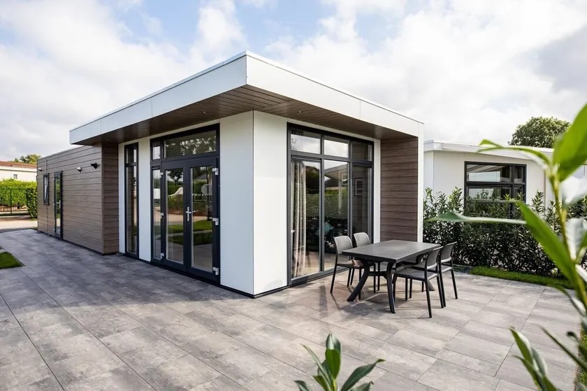 Modern holiday home with a view of a tranquil pond - Image 1