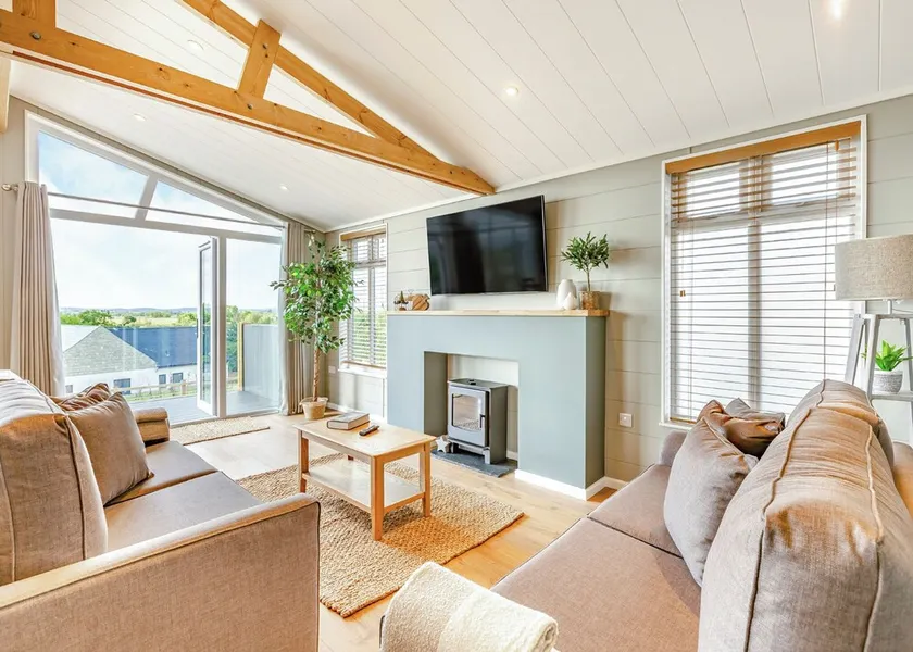 Luxurious lodge with vaulted ceilings and a welcoming feature fireplace. - Image 1