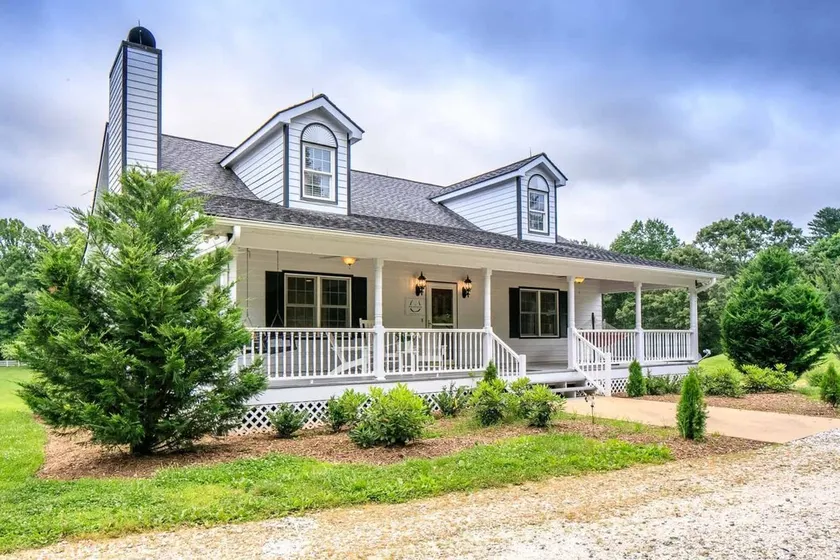 Modern and spacious home surrounded by scenic willow trees. - Image 1