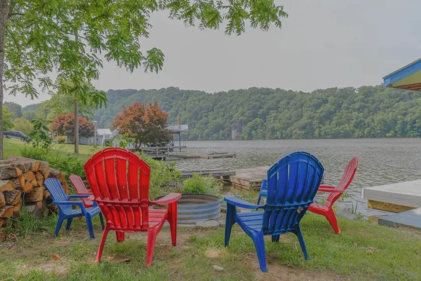 Waterfront retreat with private dock, wraparound deck & stunning lake views. - Image 1