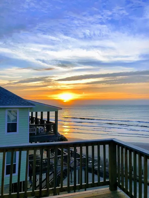 Martinis & Bikinis, a beach front house with toes in the sand drink in the hand. - Image 1