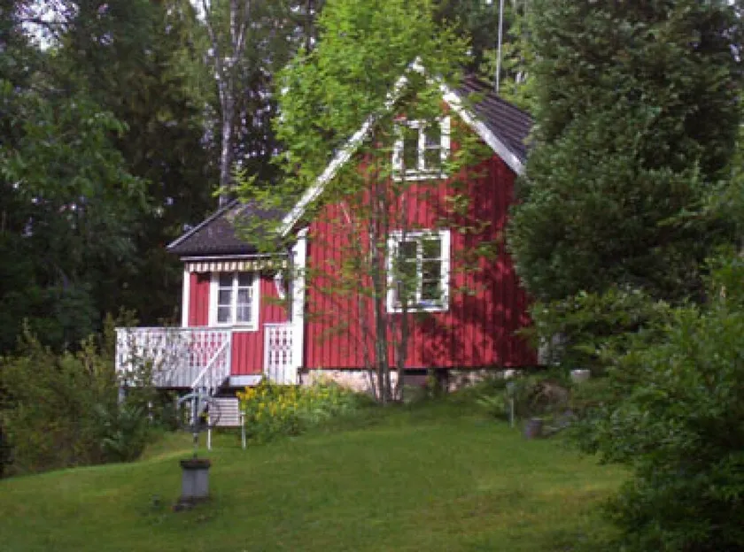 Red and white cottage with a boat not far from the lake - Image 1