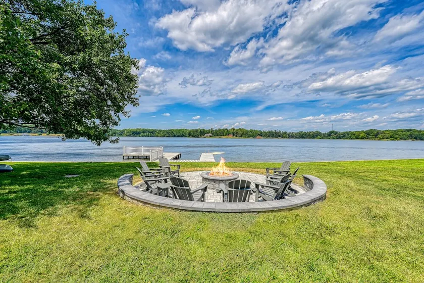 Lakefront retreat with a large yard, stone fire pit, gazebo, deck, & dock - Image 1