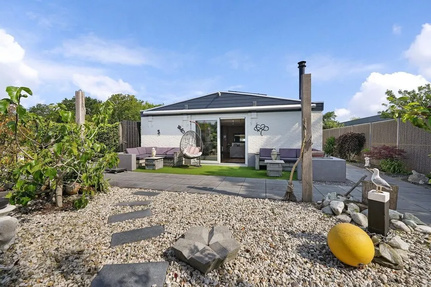 The charmingly furnished holiday home with luxurious amenities and a spacious private garden is located near the sea and dunes. - Image 1