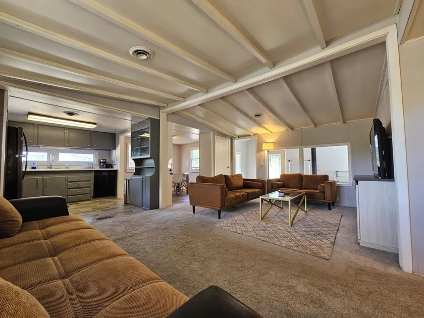 Enjoy a Peaceful environment with neighboring mini pones a fire pit to sit under the stares. roll into the oversized parking lot and enjoy this lovely modern farm home. - Image 1